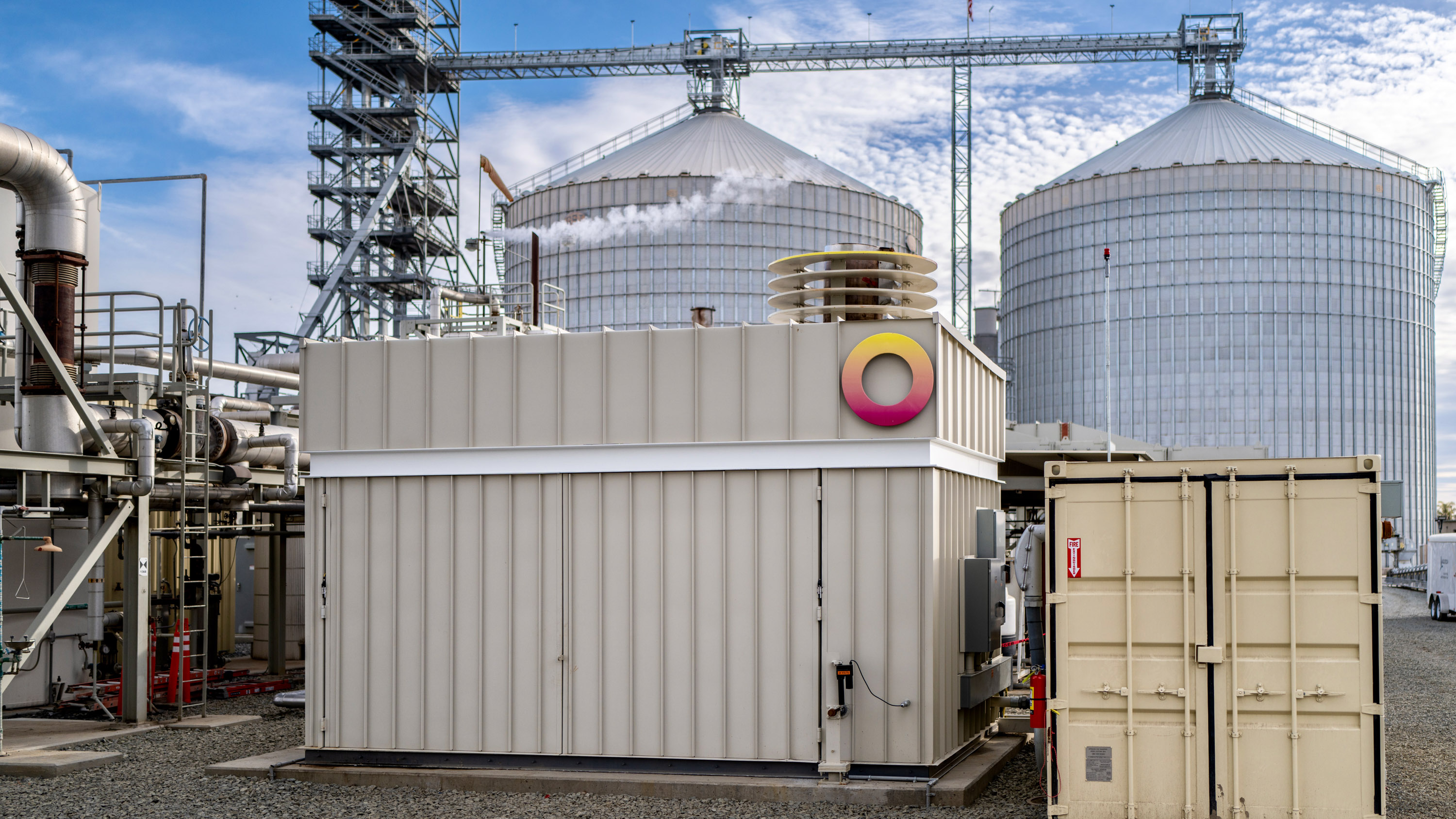 a Rondo battery in the foreground of an ethanol plant